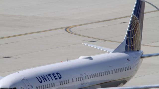 A United Airlines plane with the Continental Airlines logo on its tail, sits at a gate at O'Hare International airport in Chicago October 1, 2010.  REUTERS/Frank Polich  