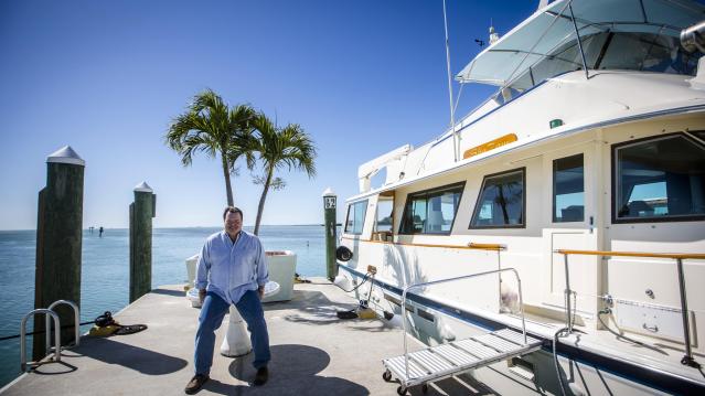 Former Air Force C-130 pilot Brian Hall, a businessman who wants to start 4-hour round trip service between Marathon in the Florida Keys and Havana, poses for or a picture in the the Marathon Marina in Marathon, Florida February 20, 2015. REUTERS/Mark Bli