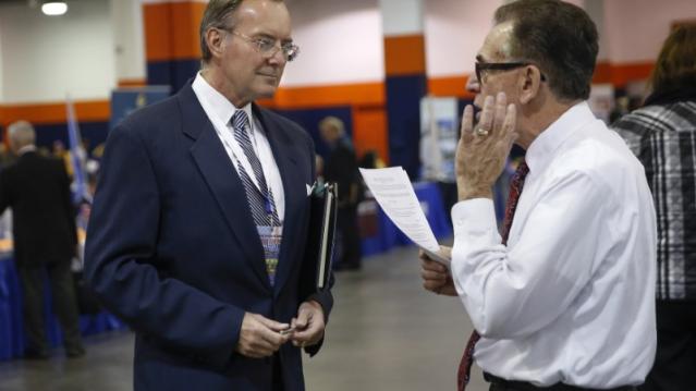 A man speaks with a job recruiter at the Nassau County Mega Job Fair at Nassau Veterans Memorial Coliseum in Uniondale, New York October 7, 2014.  REUTERS/Shannon Stapleton