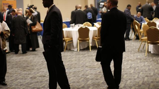 FILE PHOTO: Job seekers stand in a room of prospective employers at a career fair in New York City, October 24, 2012.   REUTERS/Mike Segar   