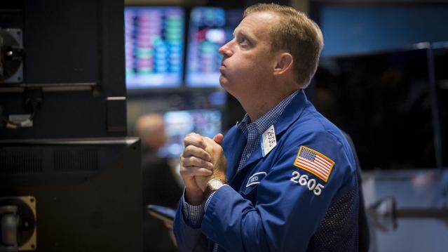 Specialist trader Zelles works at his post on the floor of the New York Stock Exchange 