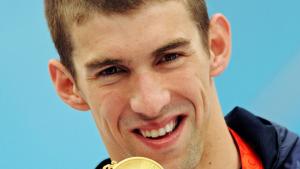 MICHAEL PHELPS GOLD MEDAL - 4th of 8Michael Phelps of the U.S holds his gold medal after winning the men's 200 meters butterfly swimming final at the National Aquatics Center during the Beijing 2008 Olympic Games August 13, 2008. Phelps swam his way into 