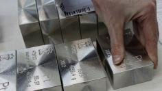 An employee sets out and sorts ingots of 99.97 percent pure platinum at the Krastsvetmet nonferrous metals plant in Russia's Siberian city of Krasnoyarsk