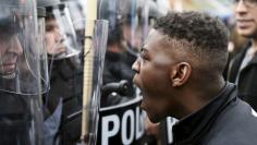 A demonstrator confronts police near Camden Yards during a protest against the death in police custody of Freddie Gray in Baltimore