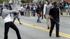 Demonstrators throw rocks at Baltimore police during clashes in Baltimore