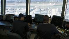 Air traffic controllers talk with pilots inside the control tower at Los Angeles International Airport (LAX) in  Los Angeles, California