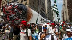 Supporters of legalization of marijuana carry large inflatable joint during protest march on first day of 2016 Democratic National Convention in Philadelphia, Pennsylvania