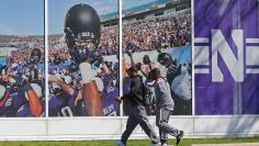 Northwestern University football players Chi Chi Ariguzo and Traveon Henry walk off the campus where athletes voted to determine if they want to form a union in Evanston