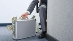 Businessman with briefcase of money