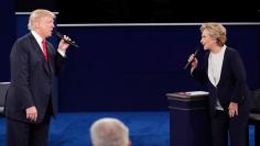 Republican U.S. presidential nominee Donald Trump and Democratic U.S. presidential nominee Hillary Clinton speak during their presidential town hall debate at Washington University in St. Louis