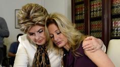 Summer Zervos is embraced while speaking to reporters about allegations of sexual misconduct against Donald Trump during a news conference in Los Angeles