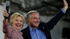 Democratic U.S. presidential candidate Hillary Clinton and U.S. Senator Tim Kaine (D-VA) wave to the crowd during a campaign rally at Ernst Community Cultural Center in Annandale