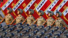 Soldiers of the Peoples Liberation Army (PLA) of China stand in formation as they gather ahead of a military parade to mark the 70th anniversary of the end of World War Two, in Beijing