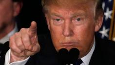 Republican U.S. presidential candidate Donald Trump reacts on stage during his victory speech at his 2016 New Hampshire presidential primary night rally in Manchester