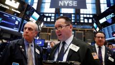 Traders work on the floor of the NYSE
