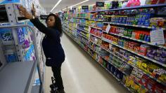 Mamie Penn works sorting shelving displays as workers prepare for the opening of a Walmart Super Center in  Compton, California