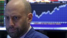 Traders work on the floor of the NYSE 