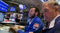 Traders work on the floor of the New York Stock Exchange shortly before the closing bell in New York