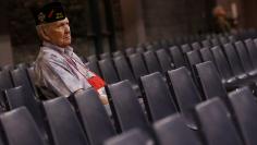 A veteran watches as U.S. Republican presidential nominee Trump speaks to the Veterans of Foreign Wars conference at a campaign event in Charlotte