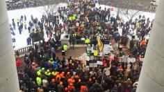 Workers gather outside the State Capitol building in Madison