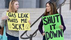 Porter Ranch residents hold signs outside Los Angeles City Hall during a demonstration on the ongoing natural gas leak in the Porter Ranch area of Los Angeles