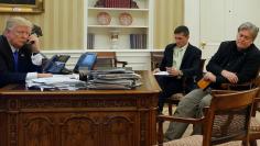 Trump, seated with Flynn and Bannon, speaks by phone with Turnbull in the Oval Office at the White House