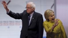 Democratic U.S. presidential candidates Senator Bernie Sanders and former Secretary of State Hillary Clinton arrive on stage before the start of the PBS NewsHour Democratic presidential candidates debate in Milwaukee