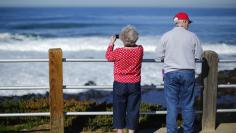 A retired couple take in the ocean during a visit to the beach in La Jolla, California