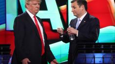 Republican U.S. presidential candidate Trump talks with rival Cruz during a break at the candidates debate in Miami