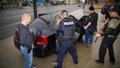 FILE PHOTO - ICE officers detain a suspect as they conduct a targeted enforcement operation in Los Angeles