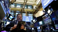 A trader works on the floor of the NYSE