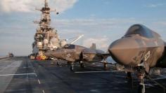 F-35 Bravo Lightning II stand ready on the deck of amphibious assault ship USS Wasp for day two of the first phase operational testing in the Atlantic Ocean