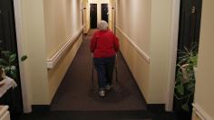 Inez Willis walks down the hallway to visit a neighbor at her independent living complex in Maryland