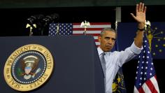 U.S. President Barack Obama waves after speaking about the economy during a visit to Concord Community High School in Elkhart