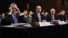 U.S. Intelligence chiefs are seated to testify before a Senate Intelligence Committee hearing on Capitol Hill in Washington