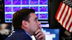 A trader works on the floor of the New York Stock Exchange (NYSE) after the opening bell in New York