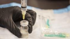 Gail Dufault, the Transitional Healthcare Coordinator at the Barnstable County House of Corrections, prepares a dose of Vivitrol at the prison in Buzzards Bay