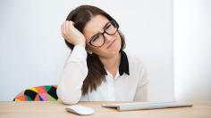 Tired businesswoman sitting at the table in office