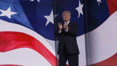 Republican U.S. presidential nominee Donald Trump applauds during the third night of the Republican National Convention in Cleveland