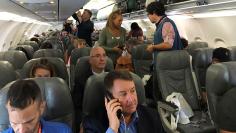 Passengers board the first regularly scheduled commercial flight between the United States and Cuba in more than half a century at Fort Lauderdale International airport in Fort Lauderdale 