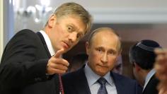 Russian President Vladimir Putin listens to his spokesman Dmitry Peskov prior to a joint news conference with Israeli Prime Minister Benjamin Netanyahu at the Bocharov Ruchei state residence in the Black Sea resort of Sochi