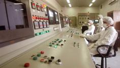Technicians of Iran's Atomic Energy Organisation in a control room supervise resumption of activities ...