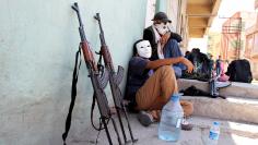 Members of YDG-H, youth wing of outlawed Kurdistan Workers Party, sit next to their weapons in Silvan, near the southeastern city of Diyarbakir, Turkey
