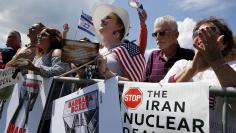 People cheer after the national anthem is played at the start of a Tea Party rally against the Iran nuclear deal at the U.S. Capitol in Washington