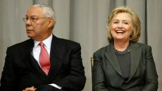 Powell and Clinton listen to remarks at a groundbreaking ceremony for the U.S. Diplomacy Center at the State Department in Washington