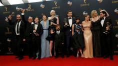 The cast of HBO's "Game of Thrones" pose backstage with their awardS at the 68th Primetime Emmy Awards in Los Angeles, California