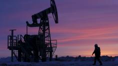 File photo of a worker walking past a pump jack on an oil field owned by Bashneft, Bashkortostan