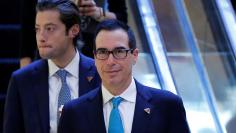 Steven Mnuchin, President-elect Donald Trump's campaign finance chairman, who has been named Treasury Secretary, walks down an escalator in the lobby of Trump Tower in Manhattan, New York