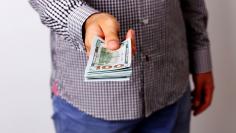 Closeup portrait of a male hand holding US dollars