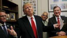 U.S. Republican presidential candidate Trump reacts after filing his declaration of candidacy to appear on the New Hampshire primary ballot in the Secretary of State's office in Concord